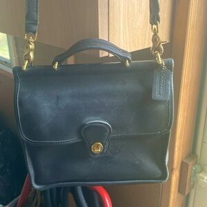 A Coach black leather purse crossbody bag.